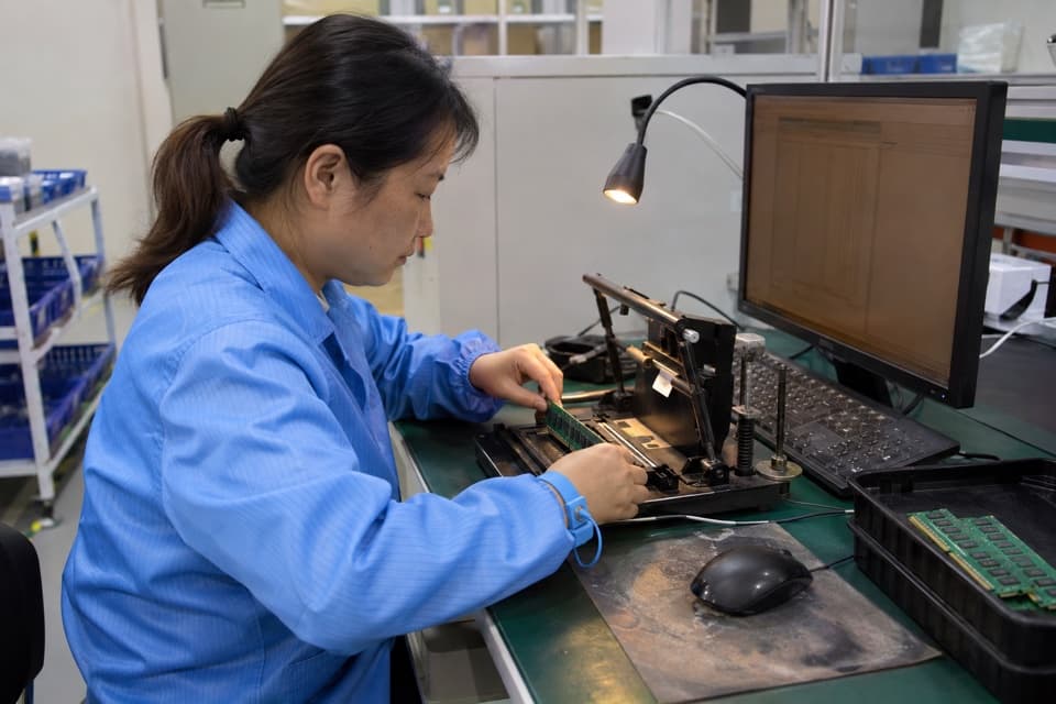 Illustrative scene of a technician testing a memory module at a workstation
